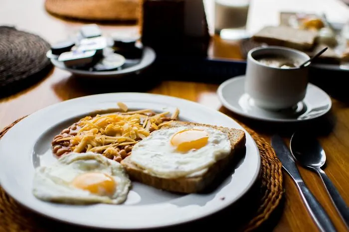 Breakfast plate with eggs, beans topped with cheese, and toast, highlighting obvious things you've just become aware of in daily meals.
