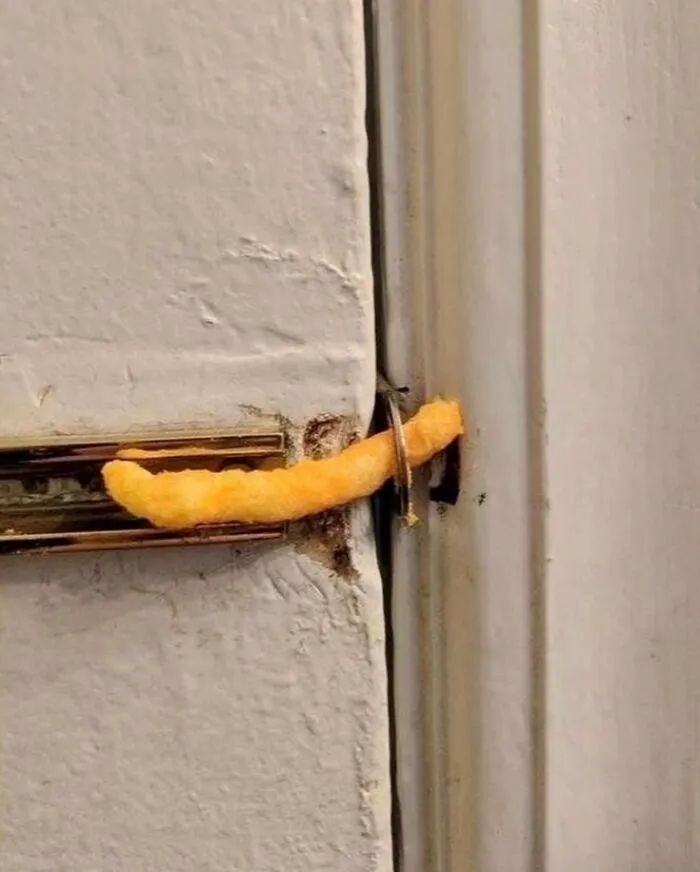 Cheese puff humorously jammed into a door lock for a whimsical twist.