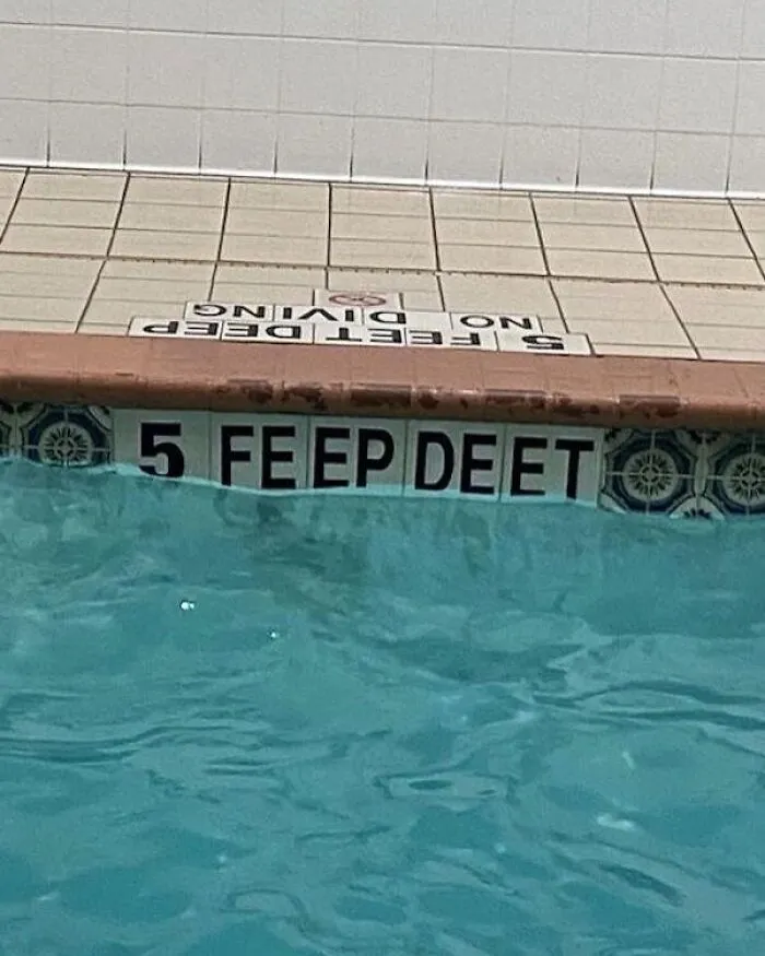 Pool with incorrect "5 Feep Deet" depth sign, bringing cool randomness to your day.