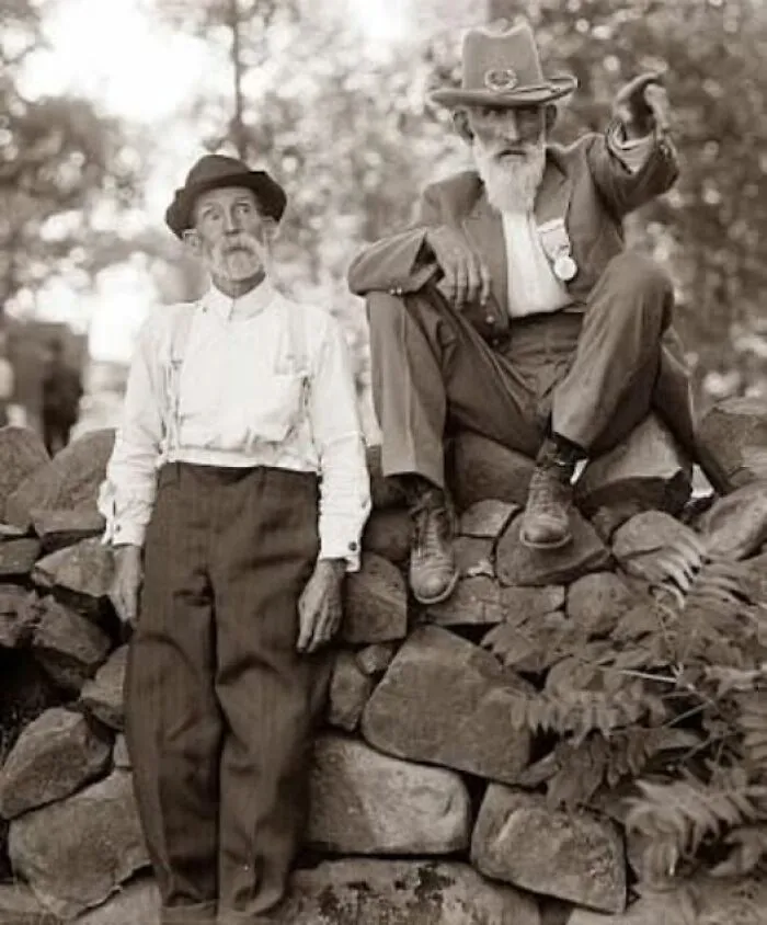 Two elderly men in vintage clothing sitting and standing on an old stone wall in antique historical photographs.