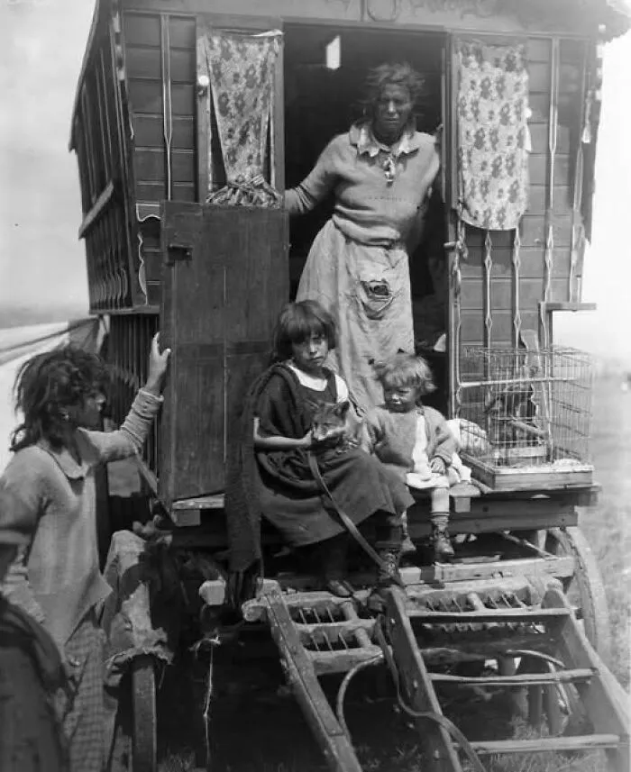 A Romani Family Pose For A Picture. 1926. Two Young Girls Sitting, One With A Fox On Her Lap