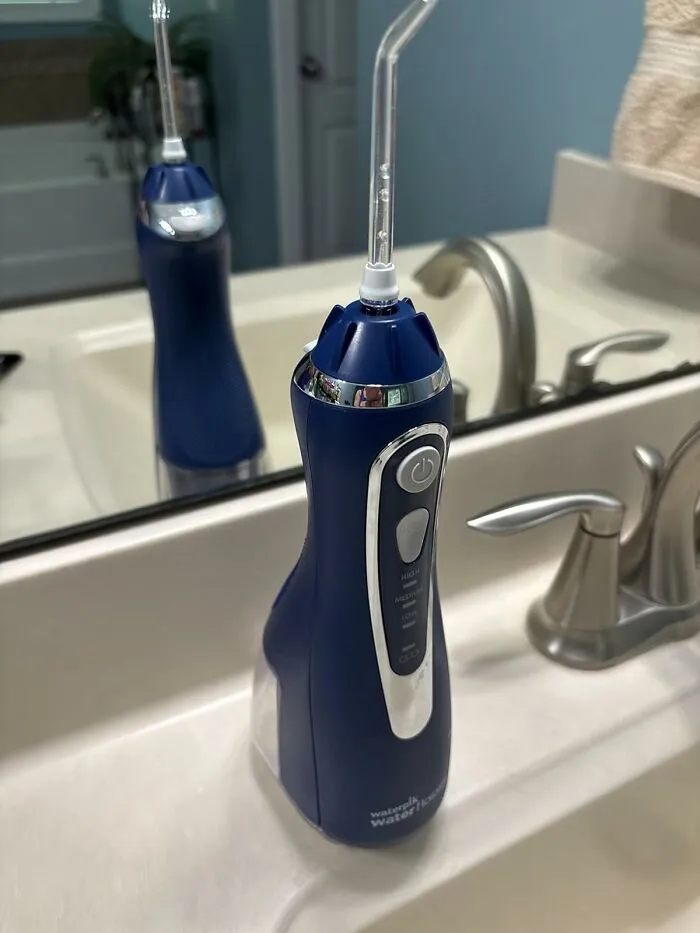 Traditional Floss Is Basically Crying In The Corner Now That This <a Style="Display:inline;" Href="Https://Www.amazon.com/Waterpik-Cordless-Rechargeable-Portable-Irrigator/Dp/B01gnvf8s8?ie=utf8&th=1&linkcode=ll1&tag=bpcrocodile-20&linkid=3487ef1a778e22010630c5a60a92a05f&language=en_us&ref_=as_li_ss_tl" Target="_blank"><span Style="Font: Inherit; Color: #d74b1f;"> Water Flosser </Span> Has Entered The Chat To Give Your Gums The Glow-Up They Deserve