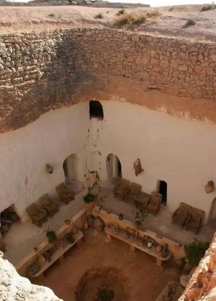 Carved Deep Into The Earth, The Damous—centuries-Old Berber Cave Homes—blend Into The Landscape, Silent Survivors Of Time And Desert Winds