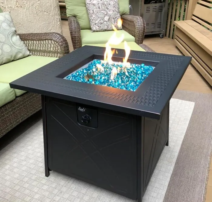 Your Patio Is About To Get So Dramatically Chic, It Might Start Demanding Its Own Instagram Account, All Because This <a Style="Display:inline;" Href="Https://Www.amazon.com/Bali-Outdoors-Square-Outdoor-Propane/Dp/B07x384cn6?ie=utf8&th=1&linkcode=ll1&tag=bppony-20&linkid=f9e6903ef79f621b538e3770154a569e&language=en_us&ref_=as_li_ss_tl" Target="_blank"><span Style="Font: Inherit; Color: #d74b1f;"> Fire Pit Table With Blue Glass </Span> Is Here To Make Your Nights Approximately 1000% More Magical And Your Neighbors 100% More Jealous