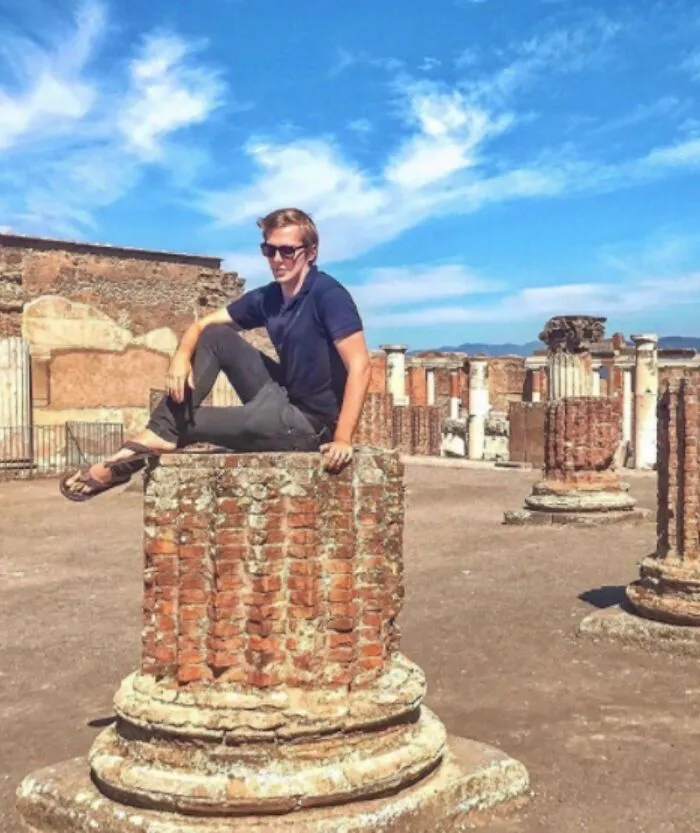 Belgian Tourist In Italy Posted A Picture Of Himself Lounging On Top Of An Ancient Column Amid The Ruins Of Pompeii, The Historical Site Where It Is Forbidden To Sit 