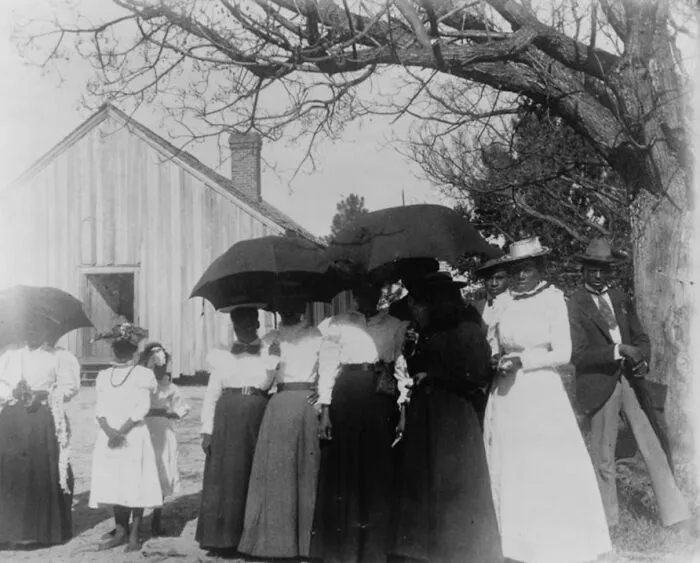 Women Holding Umbrellas