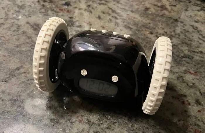 Your Snooze Button Dreams Are Officially Over Thanks To The Chaotic Energy Of An <a Style="Display:inline;" Href="Https://Www.amazon.com/Clocky-Sleepers-Annoying-Energized-Digital-Funny/Dp/B004msmugi?ie=utf8&th=1&linkcode=ll1&tag=bpgoldfish-20&linkid=eda7bebf16e344e4694b3902db3d9b43&language=en_us&ref_=as_li_ss_tl" Target="_blank"><span Style="Font: Inherit; Color: #d74b1f;"> Alarm Clock On Wheels </Span>