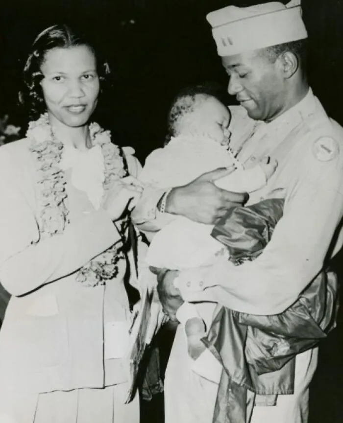 An Officer Standing Next To His Wife And Holding His Baby Son In His Hands, Honolulu