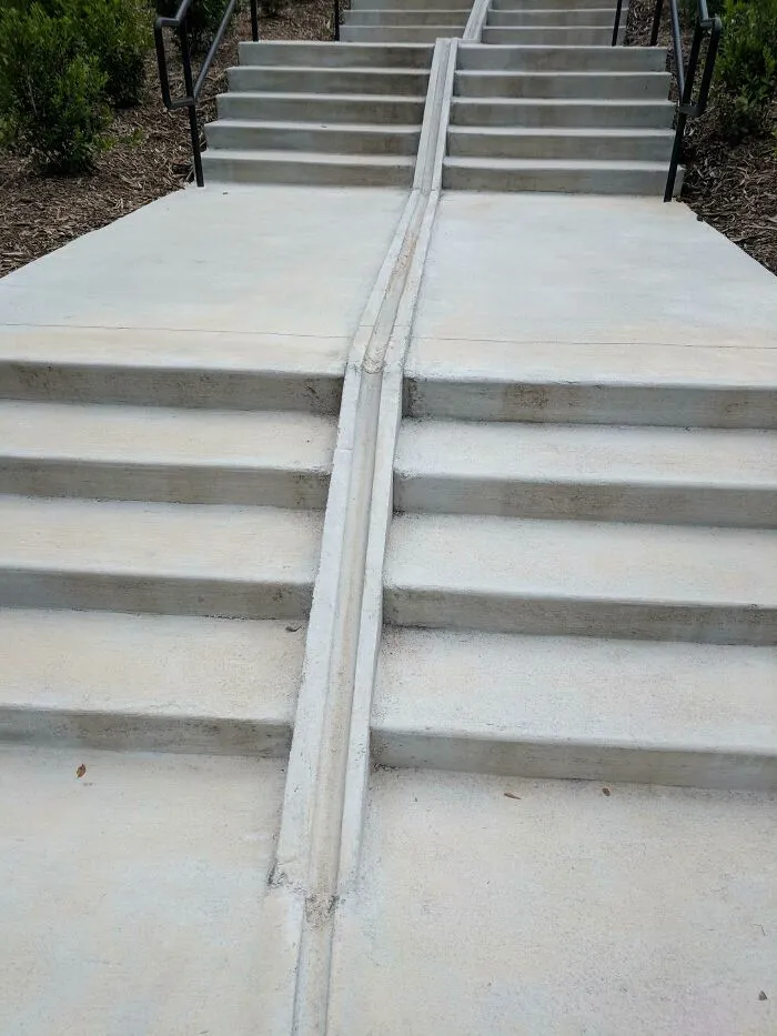 This Staircase Has A Crevice To Roll Your Bike Up The Stairs