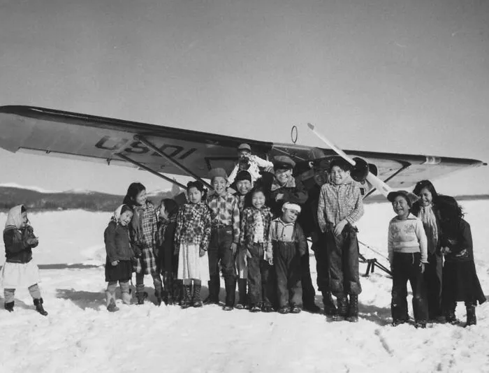 Native Alaskan Children In Front Of Small Plane On Skiis, Village Of Kaltag, On The Yukon River, 1954