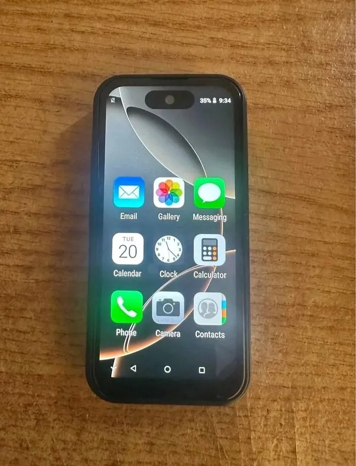 Small smartphone with a cracked screen displaying app icons, an example of unexpected fails and anything gone wrong.