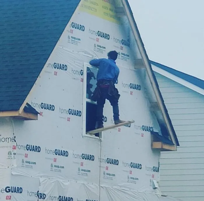 Worker on an unstable plank outside a house, illustrating unexpected fails and unfortunate anything gone wrong moments.
