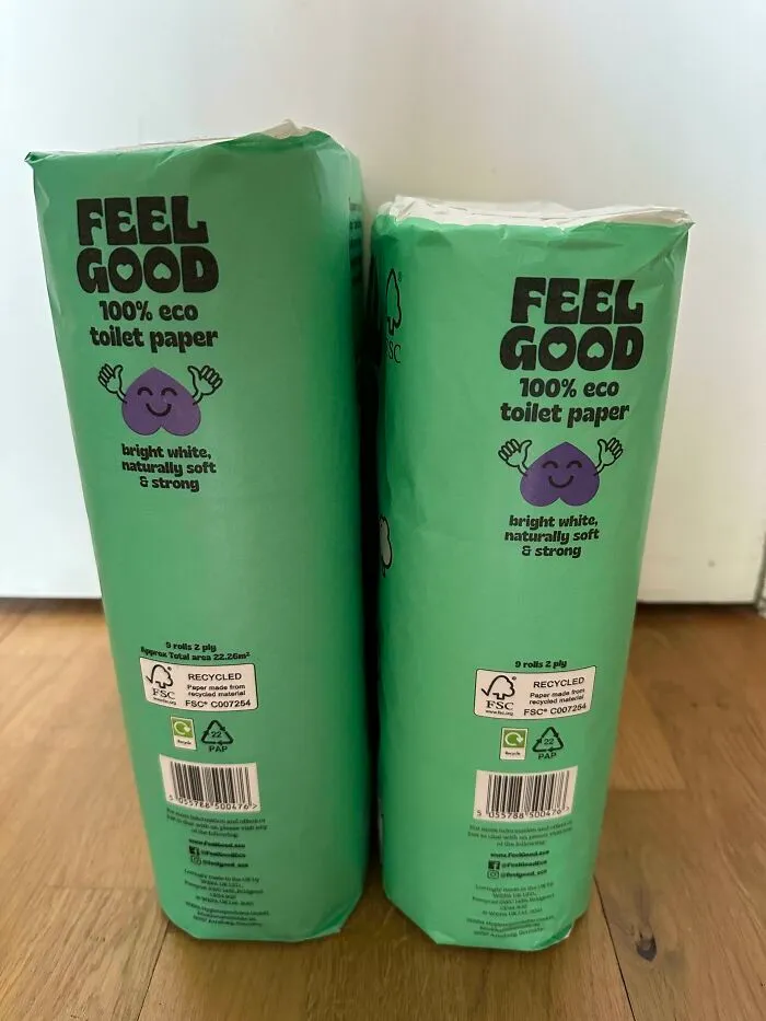 Two smaller packs of Feel Good 100% eco toilet paper placed side by side on a wooden floor highlighting product size changes.