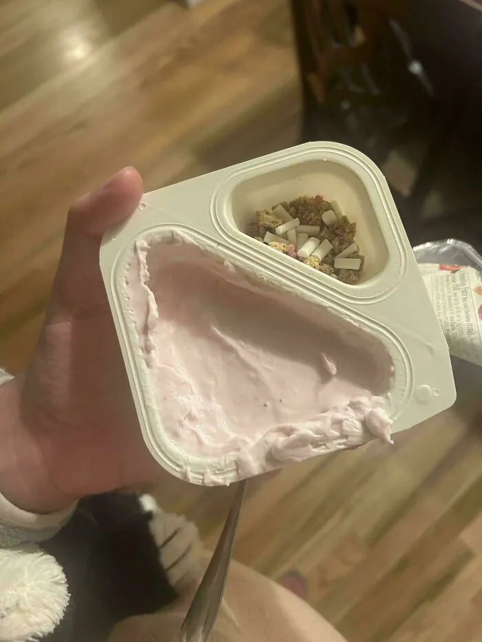 Small yogurt container with minimal granola portion showing products getting smaller and more expensive trend.