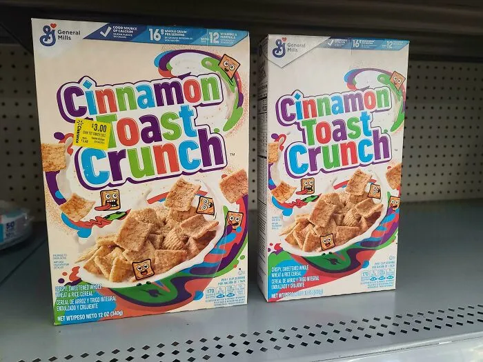 Two boxes of Cinnamon Toast Crunch cereal on a store shelf showing smaller product size and higher price trend.