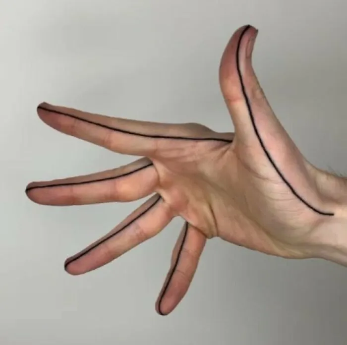 Mano con tatuajes de líneas negras simples a lo largo de los dedos y palma, ejemplos de tatuajes entre graciosos y terribles.
