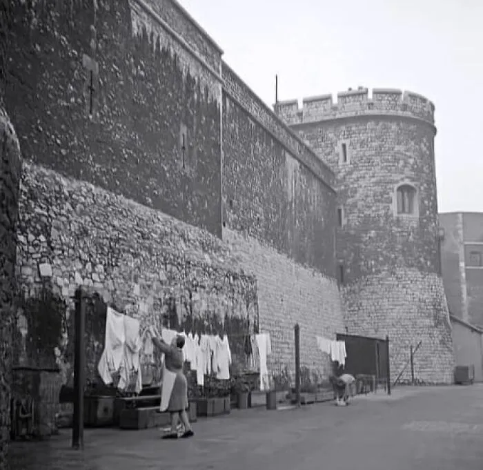 A Pair Of Housewives, Who Would Have Lived Inside The Tower's Walls Along With Their Husbands, Are Pictured Drying The Yeomen's Washing At The Foot Of One Of The Battlements