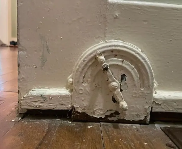 Old House Mystery. This Is Located At The Corner Of The Baseboards In An Old House. Looks Like It's Been Painted Over A Lot. Any Ideas What This Is?