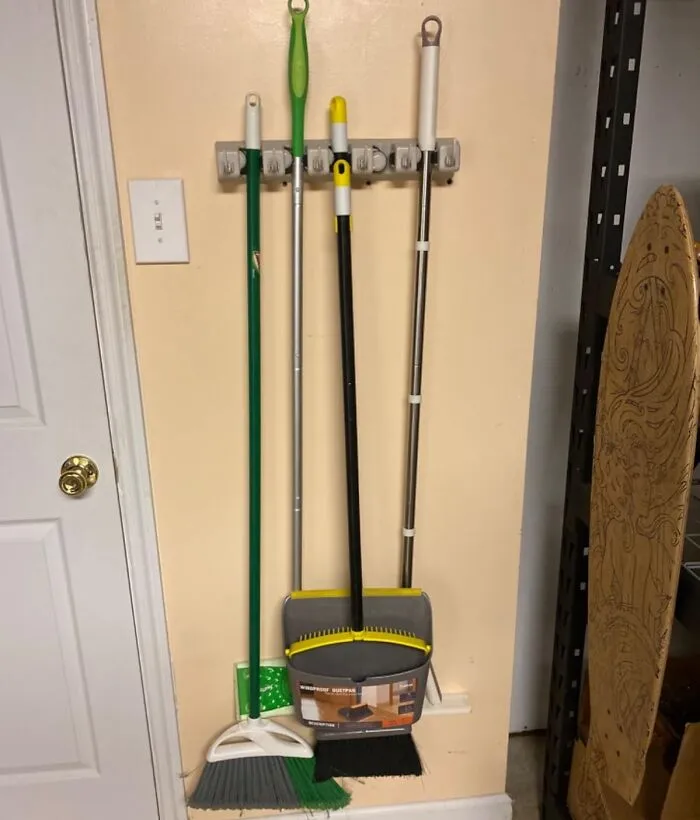 Your Mops And Brooms Can Finally Upgrade From 'That One Corner Where They Always Fall Over' To Their Own Cool Digs With <a Style="Display:inline;" Href="Https://Www.amazon.com/Storage-Organization-Plastic-Organizer-5-Position/Dp/B00eju3swy?ie=utf8&th=1&linkcode=ll1&tag=bplion-20&linkid=3eb09324fa2f30e1762990c437d4c3bf&language=en_us&ref_=as_li_ss_tl" Target="_blank"><span Style="Font: Inherit; Color: #d74b1f;"> This Wall-Mounted Mop And Broom Holder</Span> That's Basically Tiny Apartments For Your Cleaning Crew