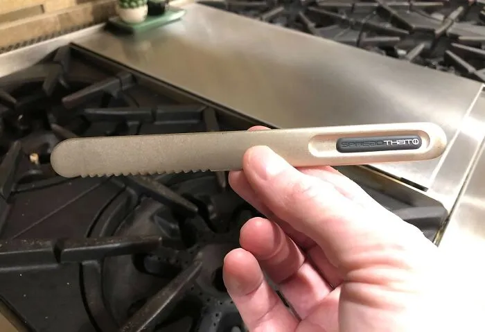 Mano sosteniendo una herramienta innovadora para cocina mostrando soluciones geniales a problemas habituales sorprendentes.