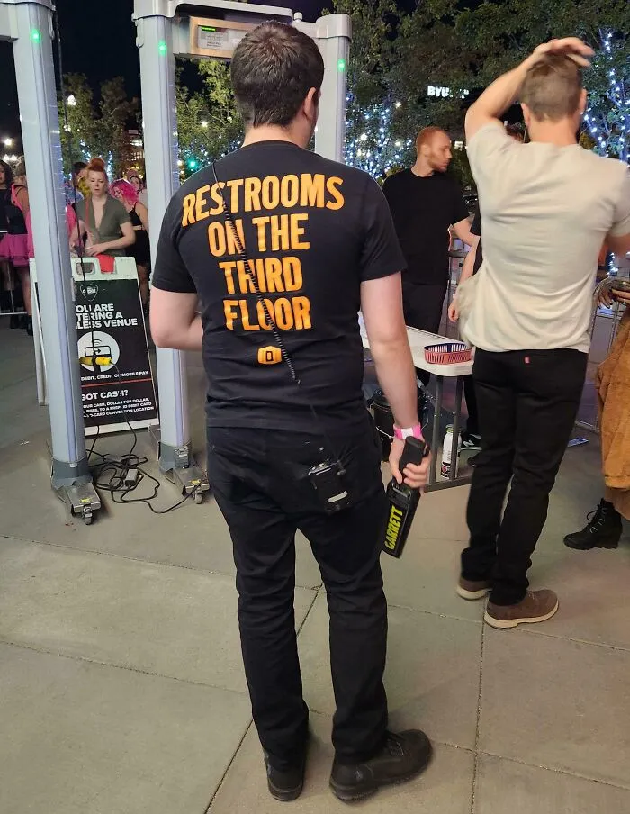The Employees At This Venue Have The Location Of The Restroom On Their Shirts