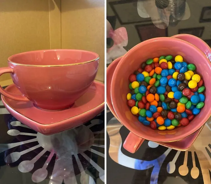 Pink teacup and heart-shaped saucer filled with colorful M&M candies, perfect for work-from-home breaks.