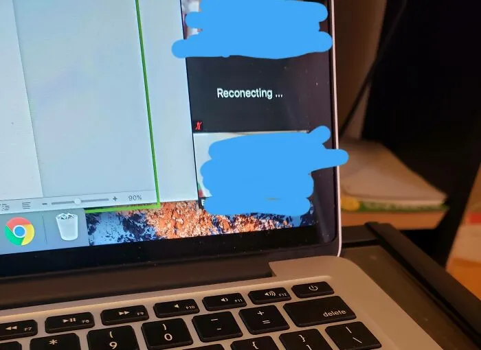 Laptop screen showing a reconnection message during a video call, illustrating challenges in work-from-home memes.