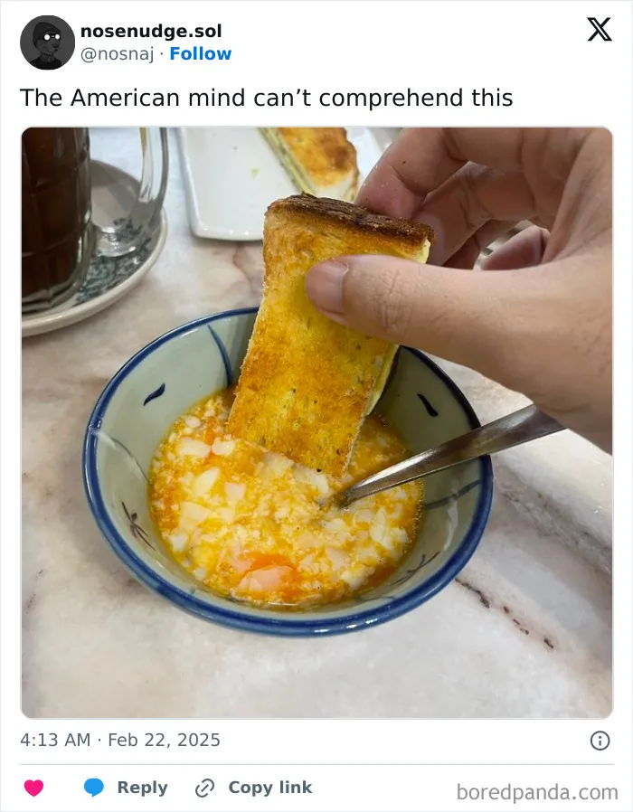 Hand dipping toasted bread into a bowl of mixed eggs, illustrating a photo that confuses the American mind.