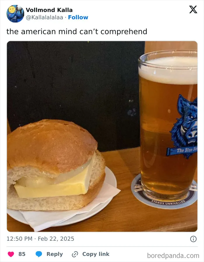 Sandwich with thick block of butter and a pint of beer on wooden table, confusing American mind concept.