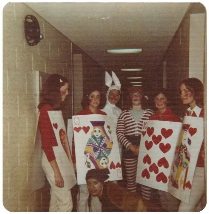 Group of people in vintage costumes including playing cards and a white rabbit, reflecting mesmerizing vintage photos history.