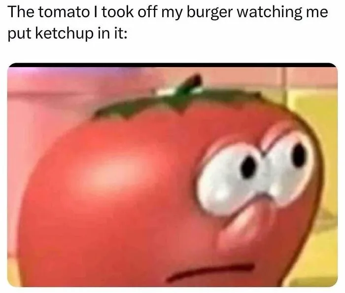 Tomato with a disapproving face watching a burger being topped with ketchup in a hilarious meme.