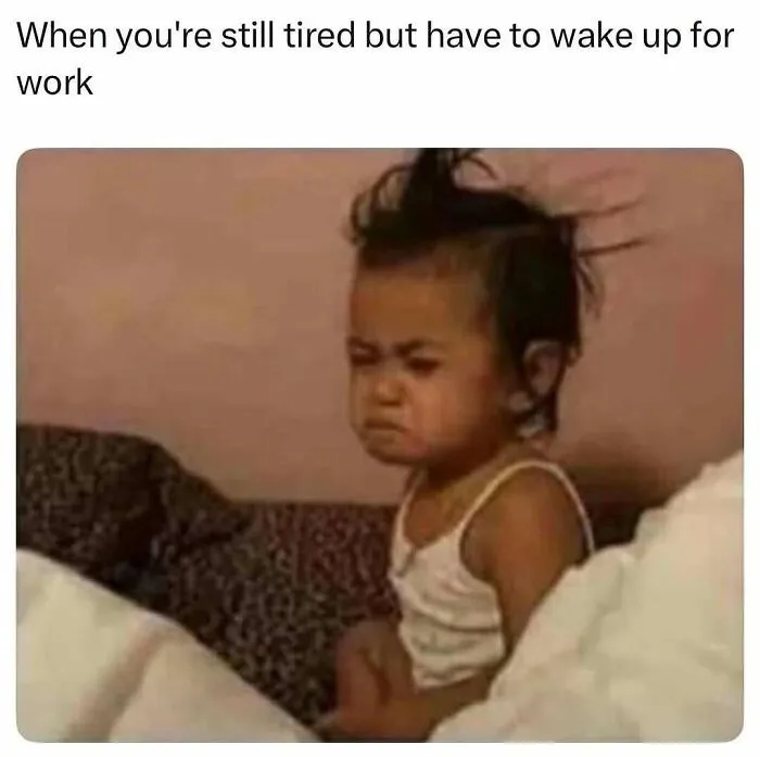 Tired toddler with messy hair sitting in bed, expressing exhaustion, a relatable meme from hilarious memes collection.