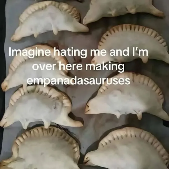 Empanadas shaped like dinosaurs on a tray, providing a fun serotonin boost from this IG page’s daily pics.