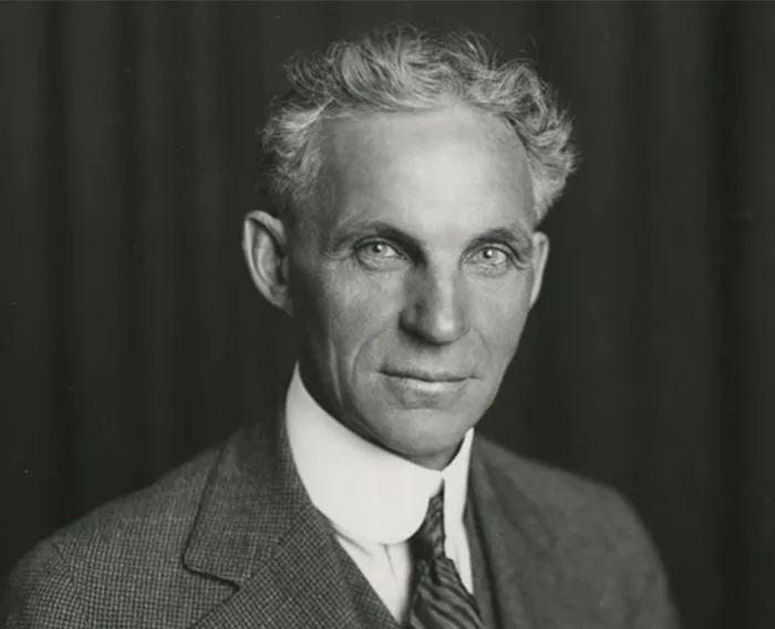Black and white portrait of a serious man in a suit, representing celebrities like Steve Jobs praised after passing.
