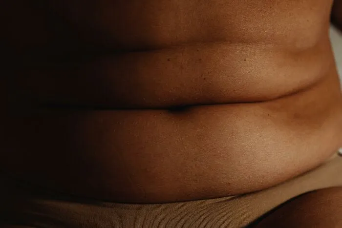 Close-up of body changes showing skin folds and texture as signs of getting older and natural aging process.
