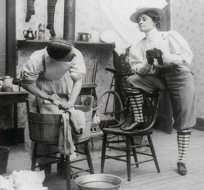 Woman In Knickers Smoking Cigarette And Looking At Man Doing Laundry