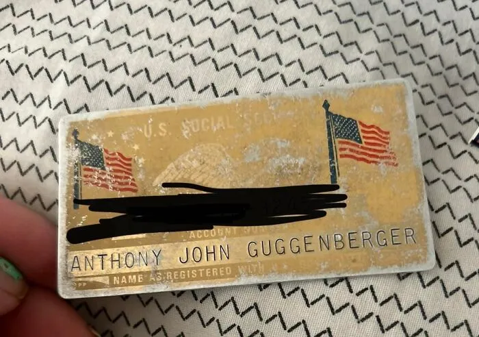 Worn vintage social security card found hidden in a wall, illustrating unexpected things found in homes and hidden places.