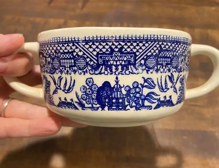 Unexpected vintage teacup found in walls and other hidden places in people’s homes with intricate blue pattern design.