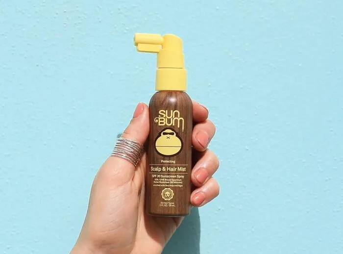 Because Nobody Told Your Scalp About Your 'Sun-Kissed Glow' Beach Goals, This <a Style="Display:inline;" Href="Https://Www.amazon.com/Dp/B08pmkdcpn?ascsubtag=7672519%2c4%2c39%2cd%2c0%2c0%2c0%2c1396%3a1%3b900%3a2%3b974%3a1%3b1338%3a1%2c46249639%2c0%2c0%2cgoogle&btn_ref=srctok-8b34f5dd826dbd77&linkcode=ll1&tag=bpowl-20&linkid=e726a4aa9b37ad3df3c2b1b58998c9a8&language=en_us&ref_=as_li_ss_tl" Target="_blank"><span Style="Font: Inherit; Color: #d74b1f;"> Sun Bum Hair Sunscreen</Span> Is Here To Prevent That Awkward, Flaky Parting Line Situation