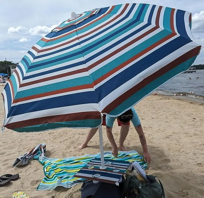 Because Wrestling A Rogue Beach Umbrella Into Submission Is Nobody's Idea Of A Relaxing Vacation Activity, This Genius <a Style="Display:inline;" Href="Https://Www.amazon.com/Dp/B08qsb4bqx?pd_rd_i=b08qsb4bqx&pd_rd_w=mm0ot&content-ID=amzn1.sym.f2f1cf8f-Cab4-44dc-82ba-0ca811fb90cc&pf_rd_p=f2f1cf8f-Cab4-44dc-82ba-0ca811fb90cc&pf_rd_r=4v1wvbw8avaha8r5dfta&pd_rd_wg=nky0g&pd_rd_r=a740f636-5ef6-43b7-A914-2dae3a20677c&sp_csd=d2lkz2v0tmftzt1zcf9kzxrhawxfdghlbwf0awm&th=1&linkcode=ll1&tag=bpowl-20&linkid=1131225e2f44bebb670648c76ce522b6&language=en_us&ref_=as_li_ss_tl" Target="_blank"><span Style="Font: Inherit; Color: #d74b1f;"> UV Blocking Umbrella With Sandbag Anchor And Cupholders</Span> Keeps You Shaded, Stable, And Your Drink Within Easy Reach