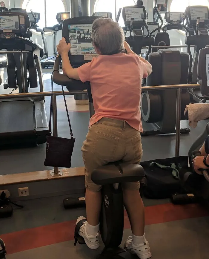 One Of The Two Only Functioning Workout Bikes On This Cruise Ship's Gym And She's Standing On It To Play Solitaire