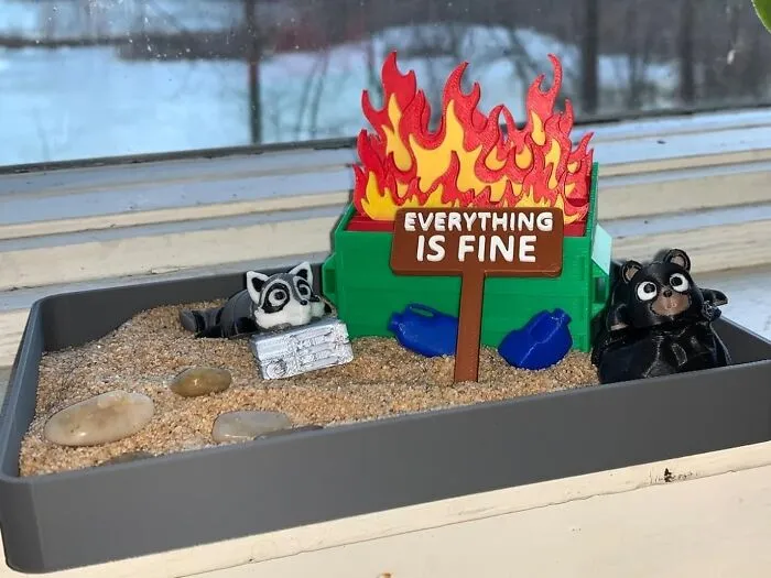 For Those Days When 'Everything Is Fine' Is A Blatant Lie, This <a Style="Display:inline;" Href="Https://Www.amazon.com/Uglaforge-Dumpster-Fire-Zen-Garden/Dp/B0dq62xtv3?ie=utf8&linkcode=ll1&tag=bpkoala-20&linkid=b144e6add1fda28e342bdeb341d8c045&language=en_us&ref_=as_li_ss_tl" Target="_blank"><span Style="Font: Inherit; Color: #d74b1f;"> Dumpster Fire Zen Garden</Span> Is The Tiny, Ironic Desk Accessory You Truly Deserve