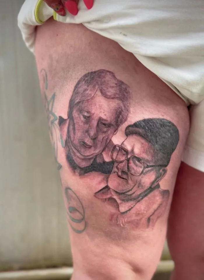 Tattoo on thigh showing two poorly drawn faces, an example of hilariously bad tattoos and inkshaming moments.