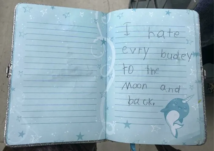 Child's handwritten note in a vintage diary, a unique historical memento people randomly found and preserved.