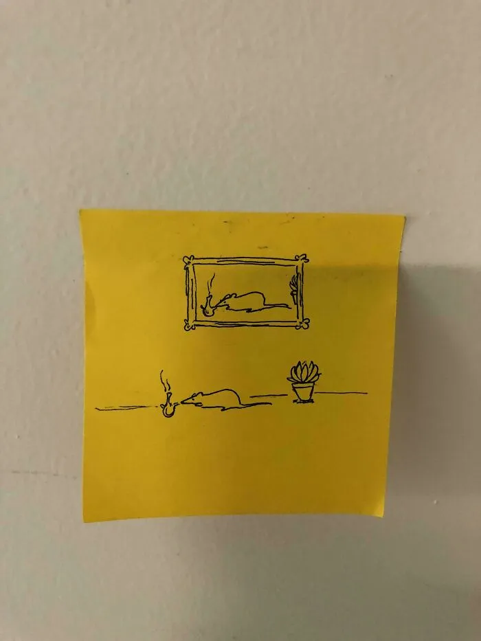 Simple line drawing on yellow sticky note of a rat smoking a pipe below a framed picture and near a small potted plant historical mementos.