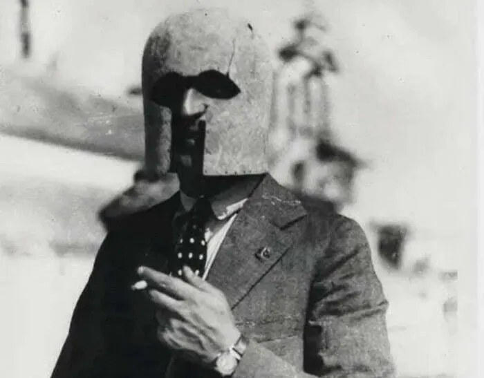 Man in vintage suit wearing a strange medieval helmet, representing weird things about history on Instagram account.