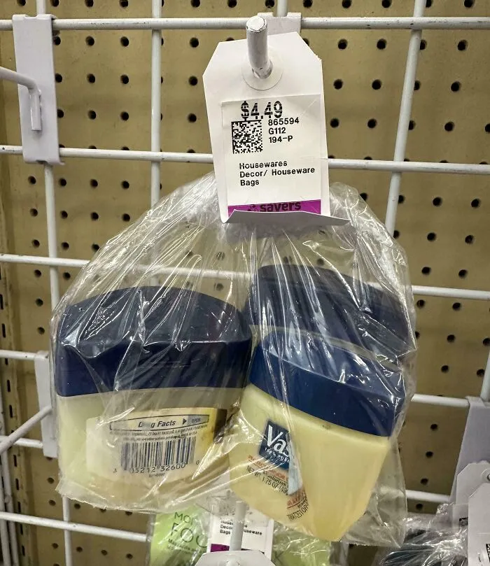 Two unopened Vaseline containers packaged together in a thrift store marked with a $4.49 price tag on a wire rack.