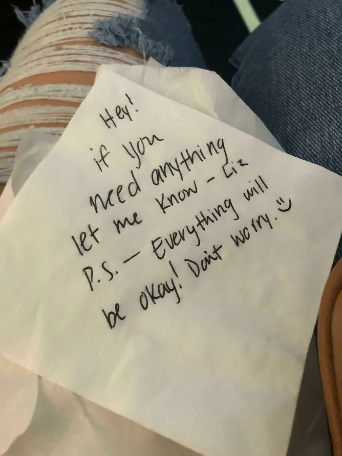 Handwritten note offering support and comfort on a napkin, reflecting inspiring moments of fear of flying passengers.