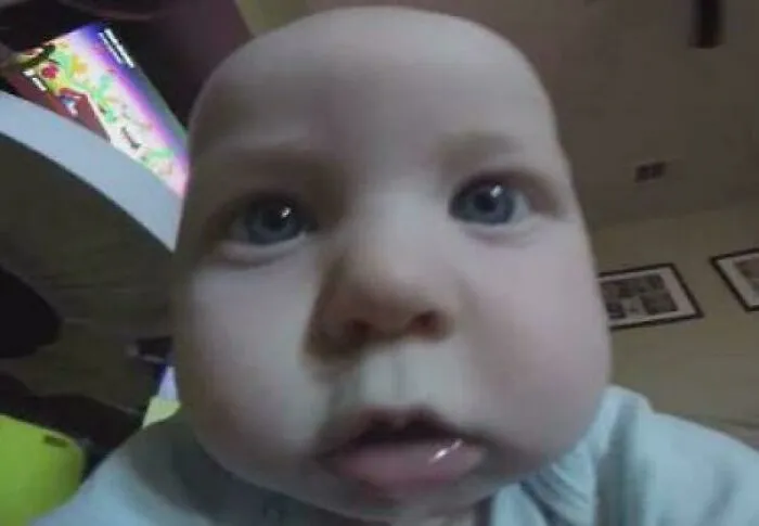 Close-up of a baby with wide eyes making a funny face, illustrating hilariously absurd internet lies humor.