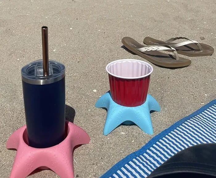These <a Style="Display:inline;" Href="Https://Www.amazon.com/Island-Genius-Vacation-Accessories-Starfish/Dp/B07vbgn88b?ie=utf8&linkcode=ll1&tag=bpkiwi-20&linkid=a223ab2da73f015bfc7bd43a26f21276&language=en_us&ref_=as_li_ss_tl" Target="_blank"><span Style="Font: Inherit; Color: #d74b1f;"> Beach Cup Holders </Span> Are Basically Tiny, Personal Thrones For Your Beverage, Ensuring It Doesn't End Up Looking Like A Sandy, Undrinkable Science Experiment